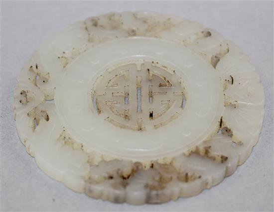 A Chinese pale celadon jade disc, 5.8cm